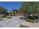 Charming home features a stone accent entry, a two-car garage, and well-maintained landscaping at 9752 E Torino Ave, Mesa, AZ 85212