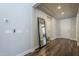 Hallway with hardwood floors, a large mirror, and views of the entryway and other rooms at 9752 E Torino Ave, Mesa, AZ 85212