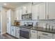 Well-equipped kitchen with stainless steel appliances, white cabinets, and stylish countertops at 9752 E Torino Ave, Mesa, AZ 85212