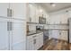 Modern kitchen features white cabinets, stainless steel appliances, and tiled backsplash at 9752 E Torino Ave, Mesa, AZ 85212