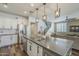 Open concept kitchen features stainless steel appliances, island seating, and stylish pendants at 9752 E Torino Ave, Mesa, AZ 85212