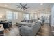 Inviting living room featuring a gray sectional sofa and a ceiling fan at 9752 E Torino Ave, Mesa, AZ 85212