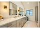 Bright bathroom features double sinks, decorative lighting and a glass enclosed shower at 10023 E Sunnyslope Ln, Scottsdale, AZ 85258