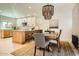 Bright dining area features a stylish chandelier, island seating, and a rustic wood dining table at 10023 E Sunnyslope Ln, Scottsdale, AZ 85258