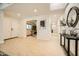 Bright entryway featuring tile floors, white walls, a skylight, and an arched doorway at 10023 E Sunnyslope Ln, Scottsdale, AZ 85258