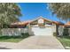 Charming home featuring a well-maintained lawn, mature trees, and a two-car garage, offering both curb appeal and practicality at 10023 E Sunnyslope Ln, Scottsdale, AZ 85258