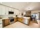 Modern kitchen featuring stainless steel appliances, stylish lighting, and white countertops at 10023 E Sunnyslope Ln, Scottsdale, AZ 85258