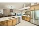 Modern kitchen open to the dining and living areas, featuring bright countertops and wood cabinets at 10023 E Sunnyslope Ln, Scottsdale, AZ 85258