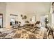 Airy living room with a large decorative rug, a white sofa, and views to the outside at 10023 E Sunnyslope Ln, Scottsdale, AZ 85258