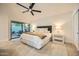 Spacious main bedroom features a sliding glass door to the backyard patio and modern ceiling fan at 10023 E Sunnyslope Ln, Scottsdale, AZ 85258