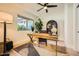 Bright office featuring a wooden desk, neutral rug, accent decor and plenty of natural light at 10023 E Sunnyslope Ln, Scottsdale, AZ 85258