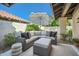 Outdoor patio space with comfortable seating, overhead umbrella and lush landscaping at 10023 E Sunnyslope Ln, Scottsdale, AZ 85258