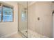 Modern shower featuring stone tile, glass door, and bronze shower fixtures at 10023 E Sunnyslope Ln, Scottsdale, AZ 85258