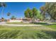 Well-manicured front yard featuring mature trees, desert landscaping and circular driveway at 10023 E Sunnyslope Ln, Scottsdale, AZ 85258