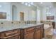Bathroom featuring double sink vanity with granite countertop and jacuzzi tub at 10033 W Jj Ranch Rd, Peoria, AZ 85383
