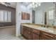 Bathroom with double vanity sinks, granite countertops, and an attached bedroom at 10033 W Jj Ranch Rd, Peoria, AZ 85383