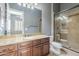 Bathroom with granite countertops, glass shower, and modern fixtures at 10033 W Jj Ranch Rd, Peoria, AZ 85383