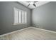 Bedroom showcasing plantation shutters, a ceiling fan, and light tile flooring at 10033 W Jj Ranch Rd, Peoria, AZ 85383