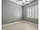 A gray bedroom with light wood-look tile and a ceiling fan at 10033 W Jj Ranch Rd, Peoria, AZ 85383