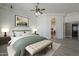 Stylish bedroom featuring a decorative ceiling fan, plush bedding, and a cozy seating bench at 10033 W Jj Ranch Rd, Peoria, AZ 85383