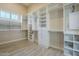 Large walk-in closet with custom shelving and natural light at 10033 W Jj Ranch Rd, Peoria, AZ 85383