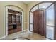 Spacious foyer with tile flooring leads to a study with custom built-in bookshelves at 10033 W Jj Ranch Rd, Peoria, AZ 85383