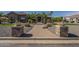 Paver walkway to home's entry flanked by stone pillars and lush landscaping at 10033 W Jj Ranch Rd, Peoria, AZ 85383