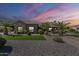 Charming single-story home with desert landscaping, stone accents, and inviting curb appeal at 10033 W Jj Ranch Rd, Peoria, AZ 85383