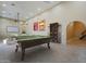 Spacious game room features a pool table, seating area, and movie projector at 10033 W Jj Ranch Rd, Peoria, AZ 85383