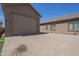 View of the property's garage and paved driveway under a clear blue sky at 10033 W Jj Ranch Rd, Peoria, AZ 85383