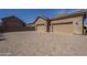Home with a large driveway leading to a 3-car garage at 10033 W Jj Ranch Rd, Peoria, AZ 85383