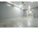 Large garage space with bright lighting and a high ceiling for ample storage at 10033 W Jj Ranch Rd, Peoria, AZ 85383