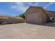 Exterior shot of the garage with a large driveway and ample parking space at 10033 W Jj Ranch Rd, Peoria, AZ 85383