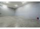 Spacious garage with concrete flooring, bright lighting, and a fire extinguisher visible at 10033 W Jj Ranch Rd, Peoria, AZ 85383