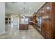 Spacious kitchen features a center island, stainless steel appliances, and dark wood cabinetry at 10033 W Jj Ranch Rd, Peoria, AZ 85383