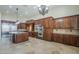 Large kitchen with center island and stainless steel appliances and dark wood cabinetry at 10033 W Jj Ranch Rd, Peoria, AZ 85383