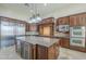 Spacious kitchen featuring custom cabinetry, granite countertops, stainless steel appliances, and an island at 10033 W Jj Ranch Rd, Peoria, AZ 85383