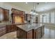 Gourmet kitchen featuring custom cabinets, granite countertops, an island, and modern stainless steel appliances at 10033 W Jj Ranch Rd, Peoria, AZ 85383