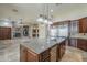 Open-concept kitchen with a kitchen island, stone countertops, and stainless steel appliances at 10033 W Jj Ranch Rd, Peoria, AZ 85383