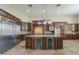Gourmet kitchen with granite countertops, stainless steel appliances, a wine fridge, and custom cabinetry at 10033 W Jj Ranch Rd, Peoria, AZ 85383