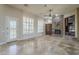 Large living room with stone fireplace, custom shelving, and plantation shutters at 10033 W Jj Ranch Rd, Peoria, AZ 85383