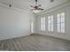 Well-lit living room with tile flooring, ceiling fan, plantation shutters and exterior access door at 10033 W Jj Ranch Rd, Peoria, AZ 85383