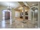 Bright living room features arched doorways, tile flooring, and a chandelier at 10033 W Jj Ranch Rd, Peoria, AZ 85383