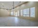 Living room with high ceilings, recessed lighting, chandelier, and door to backyard at 10033 W Jj Ranch Rd, Peoria, AZ 85383