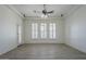 Bright living room with tile flooring, shuttered windows, and ceiling fan at 10033 W Jj Ranch Rd, Peoria, AZ 85383