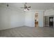 Large living room with tile flooring, ceiling fan, and adjacent doorway with decorative arch at 10033 W Jj Ranch Rd, Peoria, AZ 85383