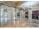 Open concept living space with stone pillars, fireplace, and wet bar at 10033 W Jj Ranch Rd, Peoria, AZ 85383