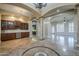 Open-concept home with columns, wet bar, and tile flooring throughout at 10033 W Jj Ranch Rd, Peoria, AZ 85383
