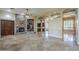 Open-concept living space boasts tile floors, stone fireplace, and seamlessly integrates with other areas at 10033 W Jj Ranch Rd, Peoria, AZ 85383