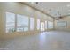 Living room with high ceilings, recessed lights, many windows, and door to backyard at 10033 W Jj Ranch Rd, Peoria, AZ 85383